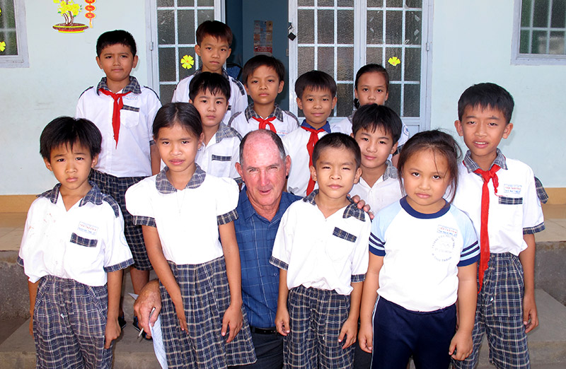 Chris with kids in school uniform